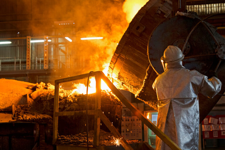 Worker,In,Protective,Clothing,Pouring,Molten,Metal,In,Foundry