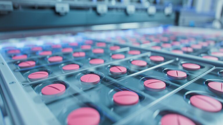 Macro,Shot,Of,Pink,Pills,During,Production,And,Packing,Process