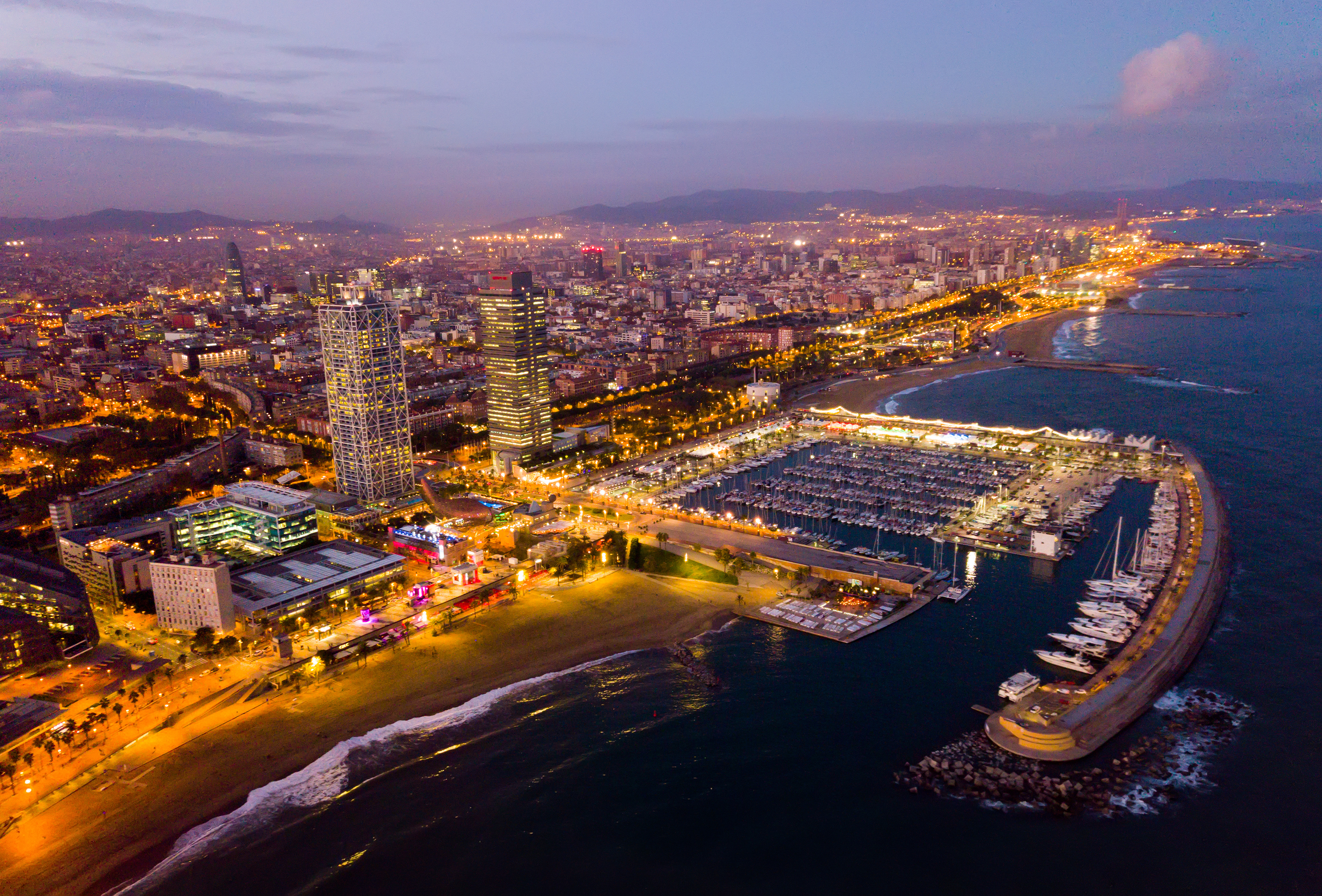 Night aerial view from drones of coast in Barcelona with sea Night aerial view from drones of coast in Barcelona with sea